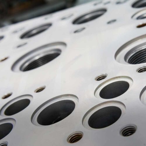 Stainless steel hydraulic manifold with holes of various sizes