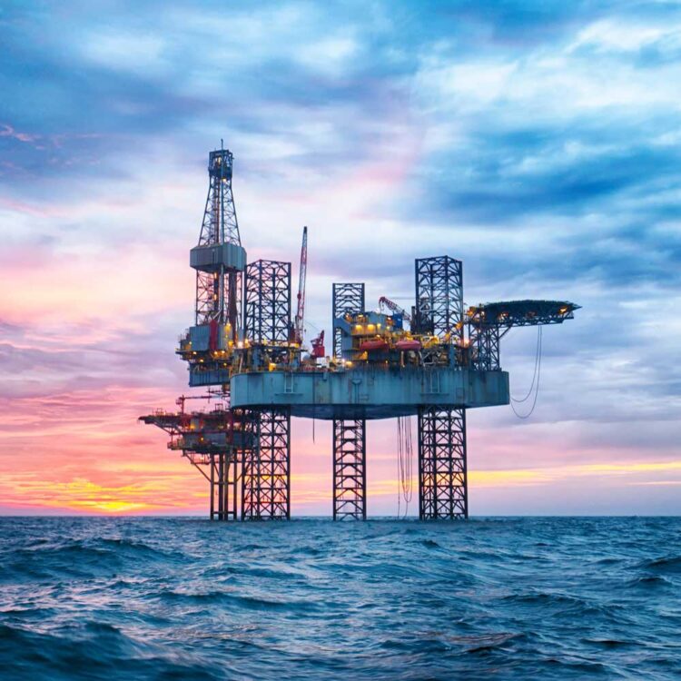 Oil rig in the sea at sunrise